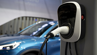 Electric car plugged into outlet charging.