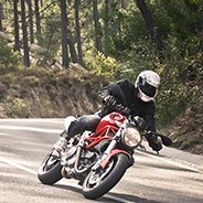 Motorcyclist driving on road.