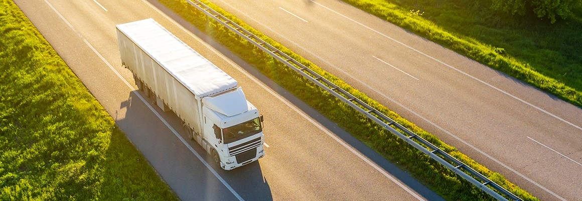 Heavy duty truck driving on highway.